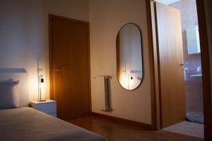 a bedroom with a bed and a mirror and a shower at Civico 18- La tua casa in centro in Latina