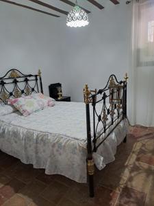 a bedroom with a bed in a white room at Casa de La Parra in Valverde de Júcar