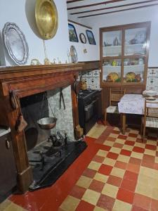 a living room with a fireplace and a table at Casa de La Parra in Valverde de Júcar