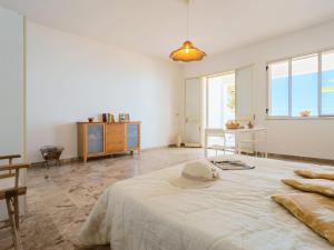 a bedroom with a bed with a hat on it at Studio Seccagrande by Interhome in Borgo Bonsignore