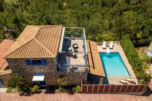 an overhead view of a house with a swimming pool at Villa Rosemarie - Luxurious Villa with Pool Just Steps Away from the Sea By Villa Mana Gers in Psarou
