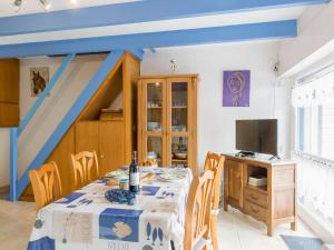 una sala da pranzo con tavolo e TV di Holiday Home Ty Kerveal - TEC210 by Interhome a Santec