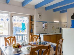 a kitchen with a table with a bowl of fruit on it at Holiday Home Ty Kerveal - TEC210 by Interhome in Santec