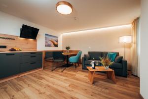 a living room with a couch and a table at Hotel Drei König in Immenstadt im Allgäu