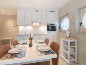 a kitchen with a table with wine glasses on it at Apartment Estepona by Interhome in Mispelburg