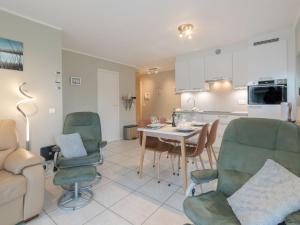 a kitchen and living room with a table and chairs at Apartment Estepona with parking by Interhome in Mispelburg