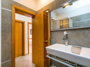 a bathroom with a sink and a mirror at Apartment Mansarda by Interhome in Rosignano Solvay