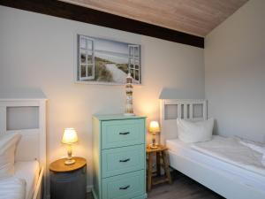 a bedroom with two twin beds and two lamps at Holiday Home Fedderwardersiel-4 by Interhome in Fedderwarderdeich