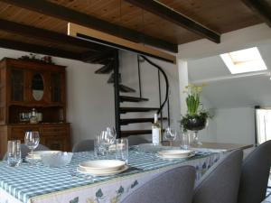 a table with chairs and a blue and white table cloth at Holiday Home Helmrich by Interhome in Schoondijke