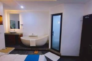 un bagno con ampia vasca bianca e lavandino di Ultimate Boutique a Siem Reap