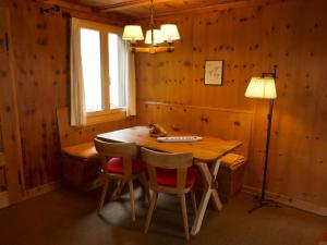 a dining room with a wooden table and chairs at Chalet Chalet Pitschun by Interhome in Grindelwald