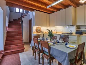 eine Küche mit einem Tisch und Stühlen sowie eine Treppe in der Unterkunft Holiday Home Casa Stella - Casa Susanne by Interhome in Spiazzi Di Caprino