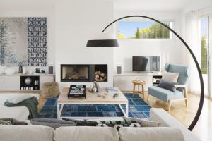 a living room with a couch and a table at BelleVue in Cala Vinyes