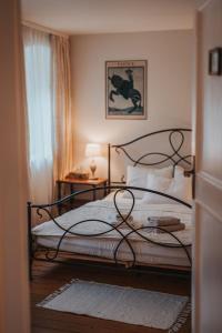 a bedroom with a bed with a wrought iron frame at Großkandlerhaus in Unterdambach