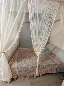 a bed with a canopy with white curtains at Casa Cirilla in Lerici +8 photos