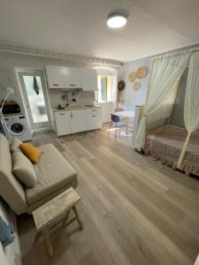 a living room with a couch and a bed and a table at Casa Cirilla in Lerici