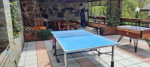 a blue ping pong table sitting on a patio at La Terrazza Casa Vacanza in Carenno