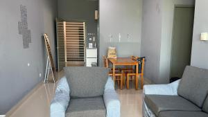 Sandakan Homestay IJM Condo 3R2B Serenity Lodge 明悦之居 - 7 Pax في Bandar Indah: غرفة معيشة مع أريكة وطاولة