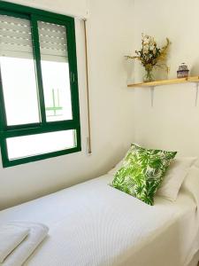 a bedroom with a bed with a pillow on it at Apartamento GUADALQUIVIR in Sanlúcar de Barrameda