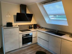 a small kitchen with a sink and a window at Ferienwohnung-Am-Sternbusch in Hau