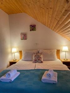 a bedroom with a bed with two towels on it at House Leonarda in Grabovac