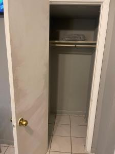 a closet with a door and a tiled floor at Best Value inside City Miami, Near Airport, Beach, Center & Metro in Miami