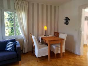 a dining room table with chairs and a lamp on it at Ferienwohnung Drei Lilien in Gummersbach