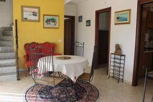 a living room with a table and chairs and stairs at Villa Wight in Olmedo