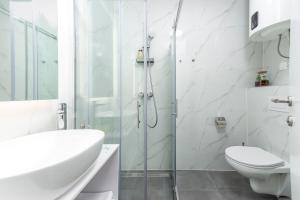 a bathroom with a shower and a toilet and a sink at City Residences in Dubrovnik