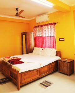 a bedroom with a large bed with a window at Kopa Ville Resort in Shānti Niketan +44 photos