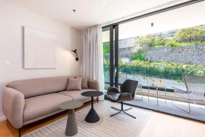 a living room with a couch and a large window at City Residences in Dubrovnik