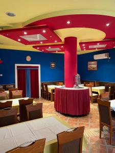 a restaurant with tables and chairs and a red ceiling at Venera Apartments in Budva