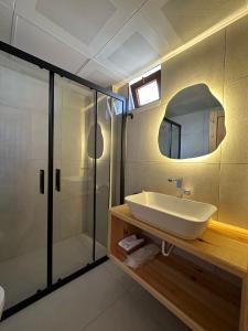 a bathroom with a sink and a shower and a mirror at Audo Studio Hotel in Antalya