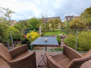 a table and chairs on a patio with a view of a garden at Zen Apartment - spacious - garden - kitchen in Karlsruhe