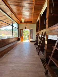 a hallway with wooden floors and wooden ceilings at Penida Hills Hostel in Nusa Penida