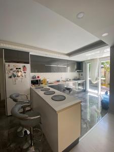 a kitchen with a counter and a refrigerator at VİLLA TADINDA,BAHCELİ MUHTESEM KONUMDA DAİRE in Istanbul