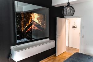 Televisyen dan/atau pusat hiburan di Moderne Wohnung im Herzen Offenbachs +3 gambar