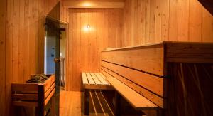 a sauna with a wooden bench in a room at Das haus in spay an der Mosel mit Sauna in Zell an der Mosel