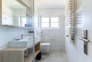 a bathroom with a sink and a toilet at Lieblingsplatz in Born +22 photos