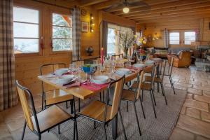 a dining room with a long table and chairs at Chalet Beauvoir 12 - OVO Network in Saint-Jean-de-Sixt