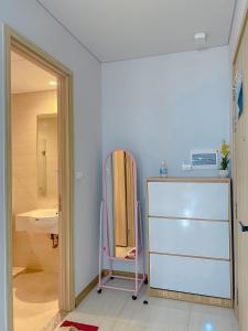 a room with a refrigerator and a sink and a mirror at Rio Ha Long Homestay - Green Bay Garden A1605 in Ha Long