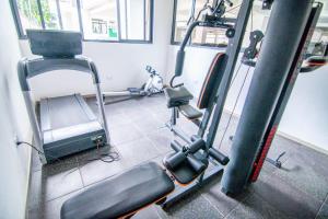 a gym with a treadmill and a simulator at Lux Suites Royal Gardens Studio Apartments in Nairobi