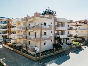 a large apartment building next to a body of water at Angela Rooms in Leptokaria