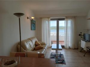 a living room with a couch and a view of the ocean at Casa Adrián in Sabardes