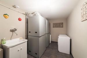 a small kitchen with a refrigerator and a sink at L'ivresse du Mont-Blanc in Saint-Gervais-les-Bains