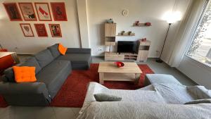 a living room with a couch and a table at Patras Juliet House in Patra