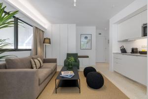 a living room with a couch and a table at Aura Homes, Contemporary Apartments in Central Athens in Athens