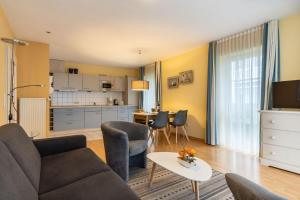 a living room with a couch and a table at Neubau-Villa-Strandidyll-Typ-4-Apartment-E4 in Binz