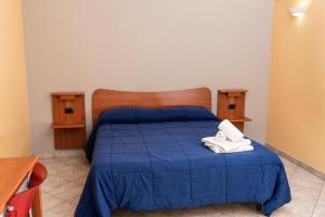 En eller flere senge i et værelse på Fontanarosa Residence