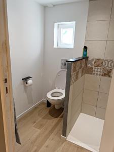 a small bathroom with a toilet and a window at Chez Aurore et Adri in Ollioules